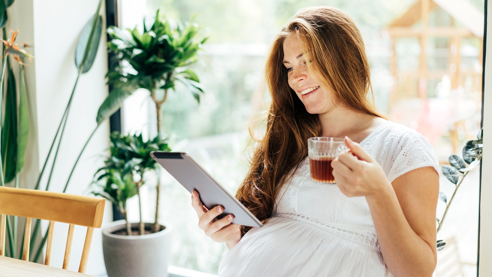 charming-pregnant-woman-drinks-a-drink-and-looks-a-2021-08-30-04-24-37-utc