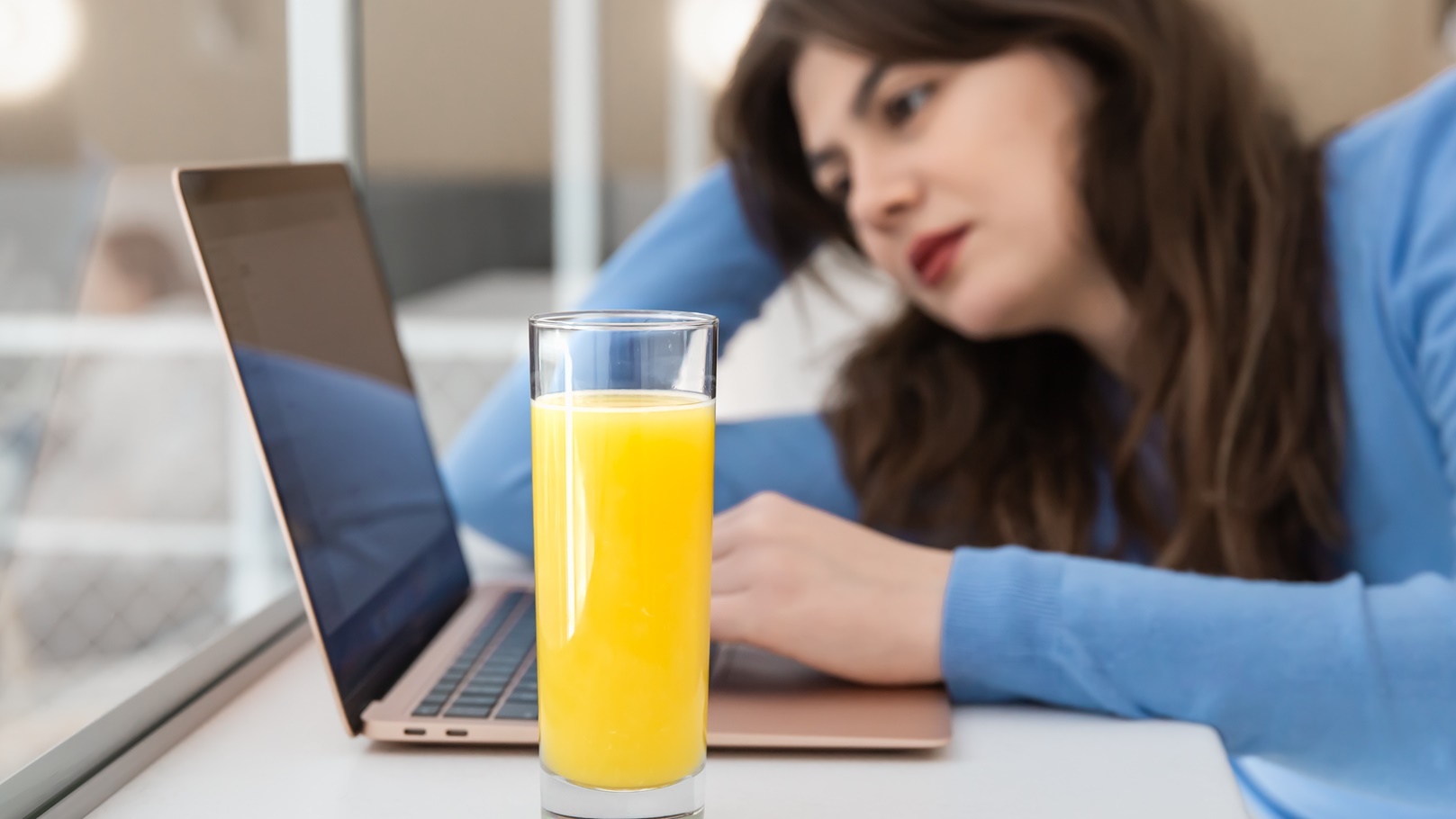 attractive-young-woman-with-a-glass-of-juice-sits-2021-12-09-20-20-35-utc (1)