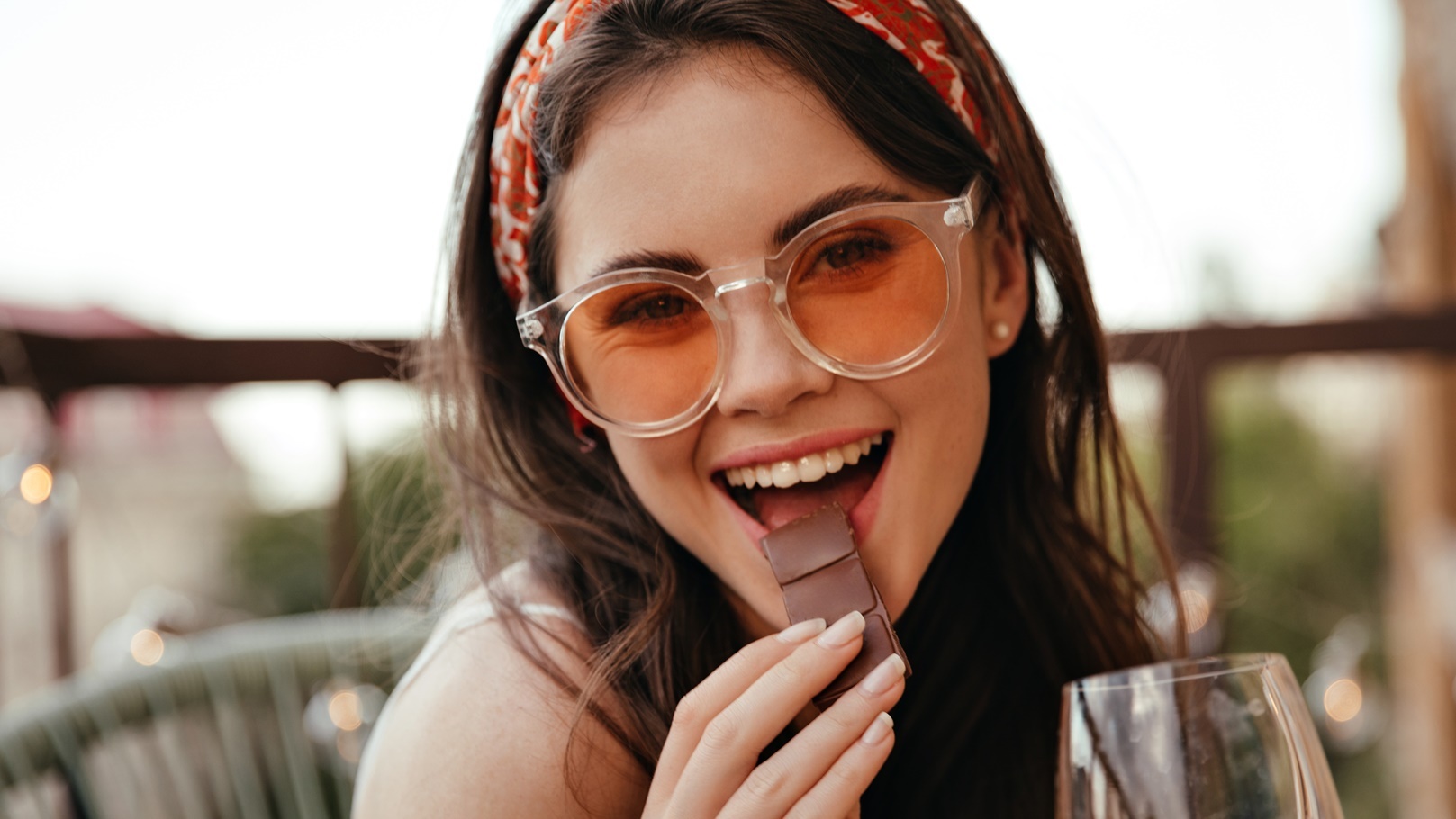 young-girl-eats-chocolate-and-holds-champagne-glas-2022-02-03-20-41-38-utc