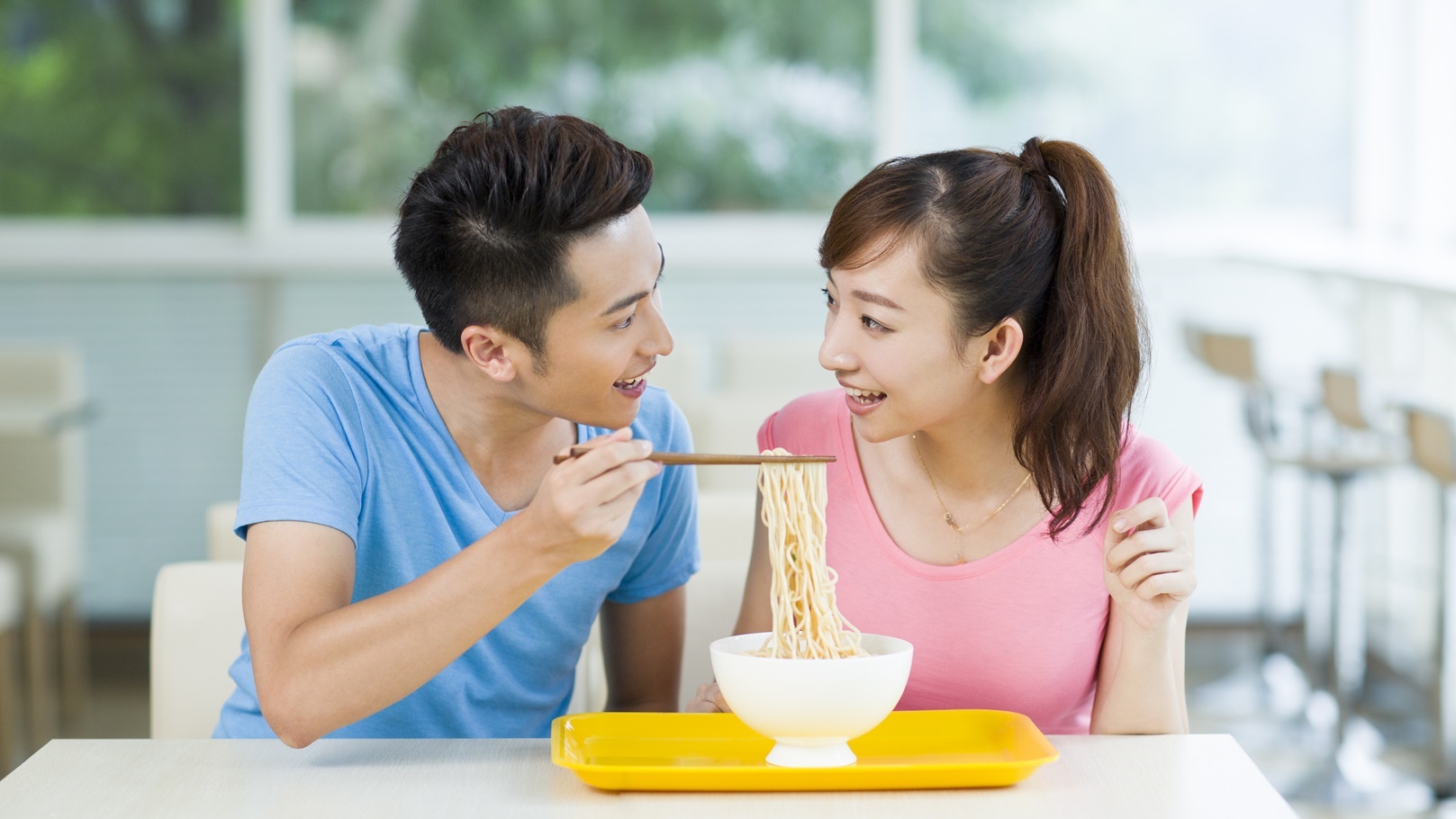 young-couple-having-noodles-in-restaurant-2022-03-24-16-34-33-utc