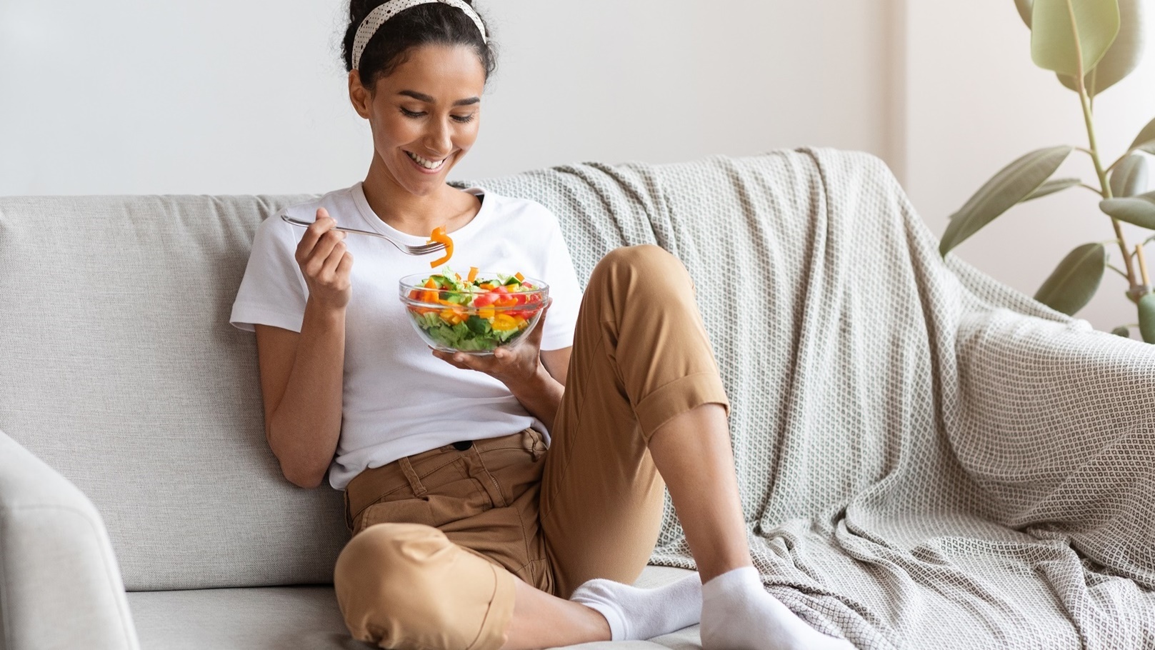 young-and-beautiful-lady-sitting-on-couch-eating-2021-09-01-15-41-27-utc