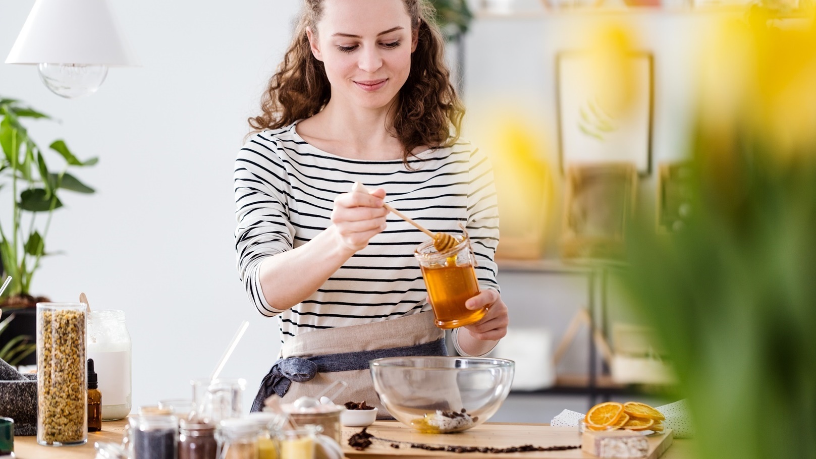 smiling-woman-pouring-honey-2021-08-26-15-45-24-utc