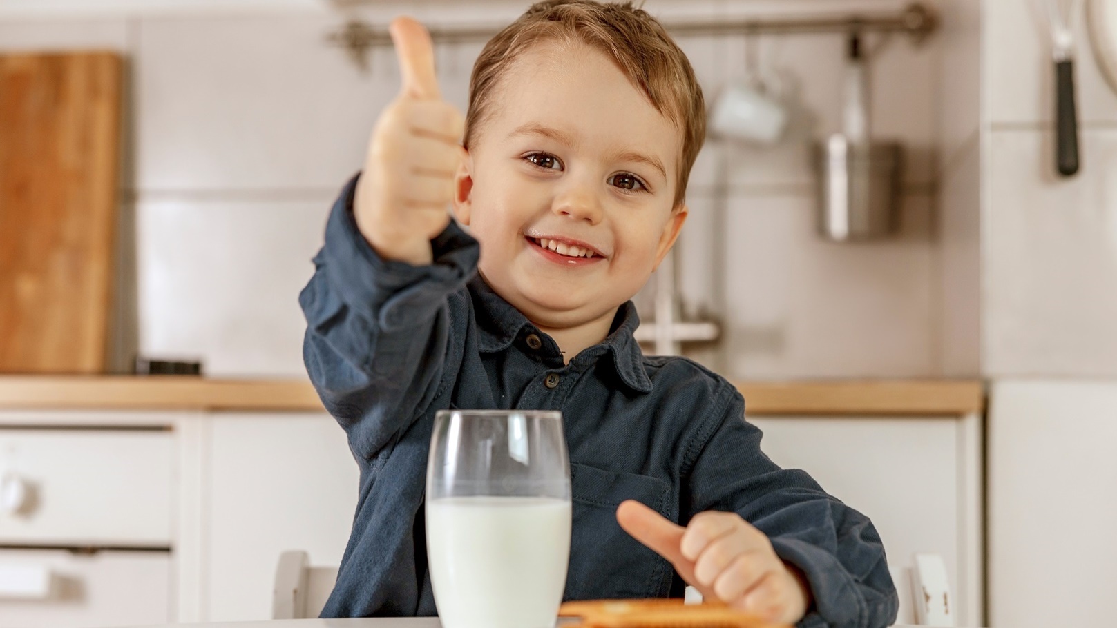 little-boy-sitting-in-the-kitchen-and-drinking-mil-2022-02-10-03-19-32-utc