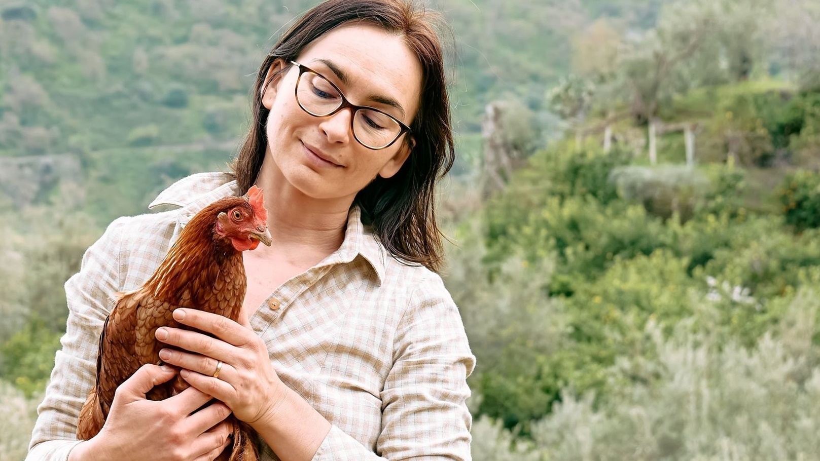 Image1_420221715454250683674-woman-holding-brown-hen-in-her-hands-in-the-farm-2022-03-29-23-21-52-utc