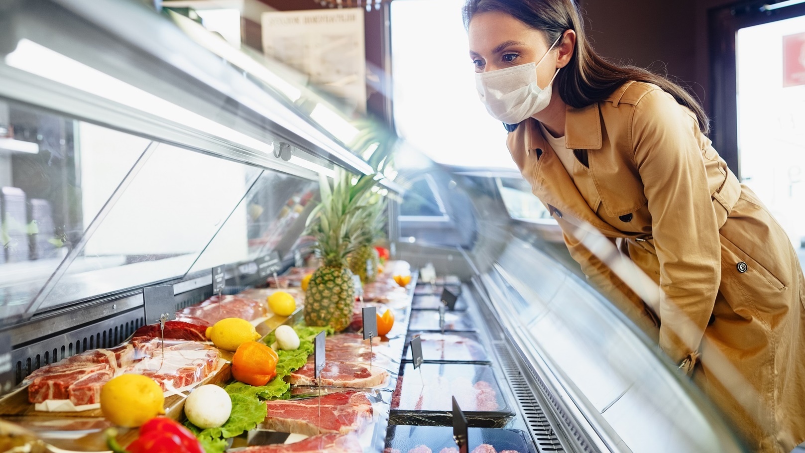 happy-young-woman-in-face-mask-choosing-meat-from-2022-02-25-02-36-21-utc