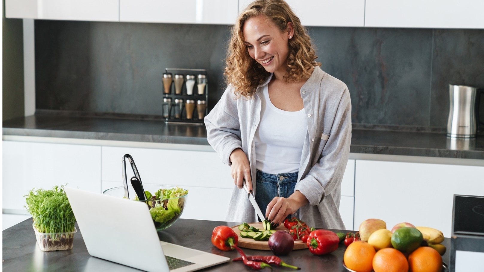 happy-young-woman-making-a-salad-at-the-kitchen-2022-02-02-04-51-14-utc